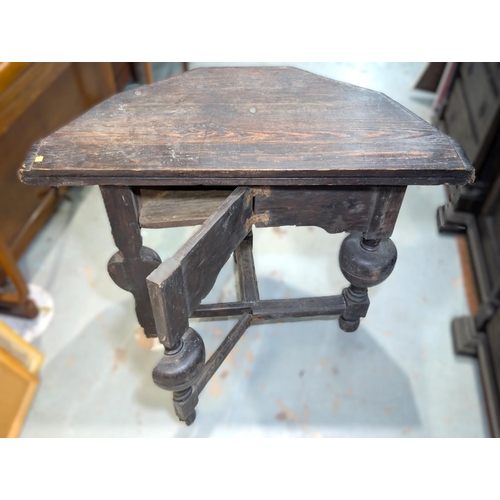 1043 - An 18th century canted oak fold over occasional table on heavy turned bulbous legs and cross stretch... 