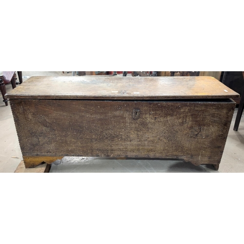 1047 - An early 18th century 4 plank oak chest with hinged lid, width 138cm (front legs cut down)