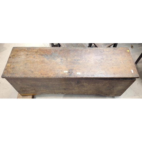 1047 - An early 18th century 4 plank oak chest with hinged lid, width 138cm (front legs cut down)