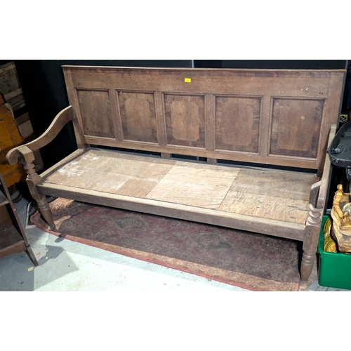 1055 - An 18th century oak settle with 5 panel back, sloped arms and turned legs, length 183cm; a 19th cent... 