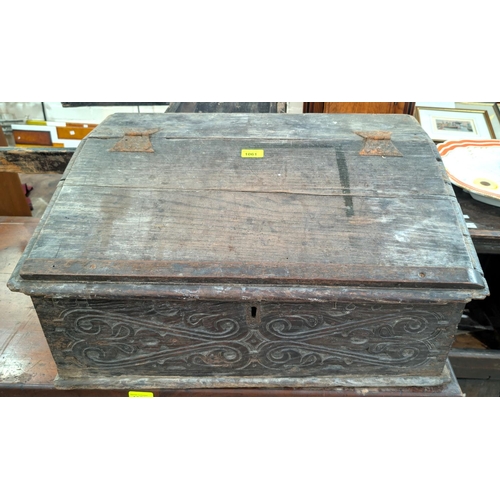 1061 - A late 17th/early 18th century carved slope front bible box and a similar box.