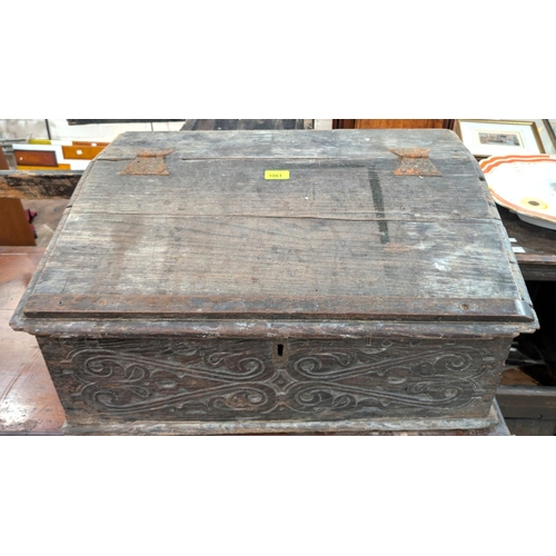 1061 - A late 17th/early 18th century carved slope front bible box and a similar box.