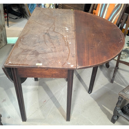 1066 - An oval Georgian mahogany drop leaf dining table on wave moulded legs; a rectangular mahogany occasi... 