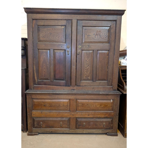 1075 - An 18th century oak full height bacon/housekeepers cupboard with moulded cornice, 2 doors with raise... 