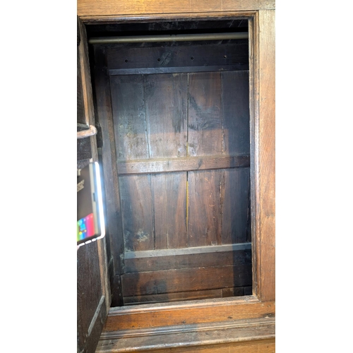 1075 - An 18th century oak full height bacon/housekeepers cupboard with moulded cornice, 2 doors with raise... 