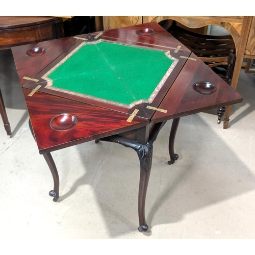 1080 - A late 19th Century/early 20th Century mahogany envelope card table on carved cabriole legs and cast... 