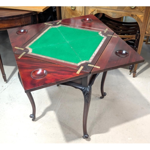 1080 - A late 19th Century/early 20th Century mahogany envelope card table on carved cabriole legs and cast... 