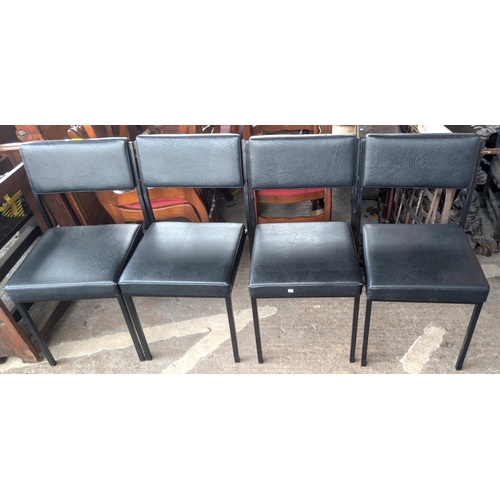 1083 - A set of six vintage Remploy black tubular metal and leather-effect office chairs.