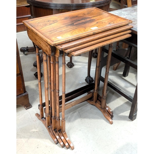 1084 - A nest of four Edwardian rosewood quartetto tables on slender turned legs and splay feet.