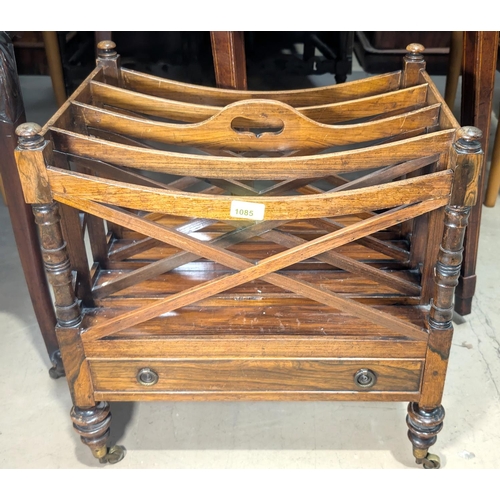 1085 - A Regency-style mahogany four-division Canterbury with turned columns and feet with lower drawer.