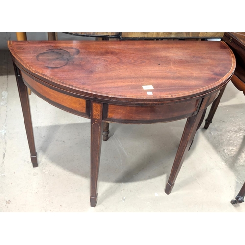 1086 - A 19th Century Georgian-style cross-banded mahogany demi-lune tea table with inlaid decoration on sq... 