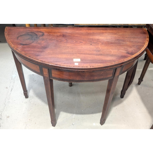 1086 - A 19th Century Georgian-style cross-banded mahogany demi-lune tea table with inlaid decoration on sq... 