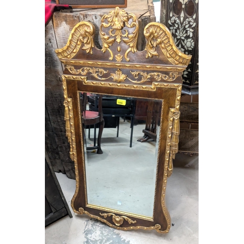 1090 - A Georgian-style rectangular bevelled edge wall mirror in parcel gilt frame with swan neck pediment ... 