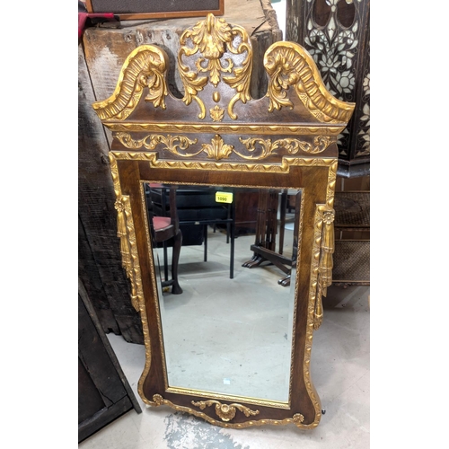 1090 - A Georgian-style rectangular bevelled edge wall mirror in parcel gilt frame with swan neck pediment ... 