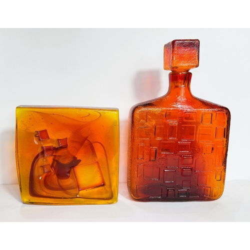 610 - An Empoli, Italy amber glass square narrow decanter with geometric design, 28.5cm; a heavy square am... 