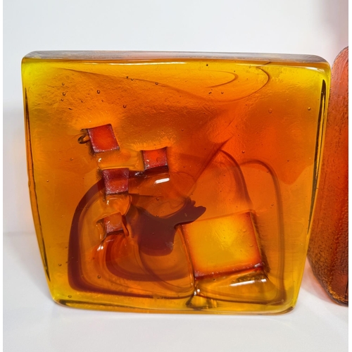 610 - An Empoli, Italy amber glass square narrow decanter with geometric design, 28.5cm; a heavy square am... 