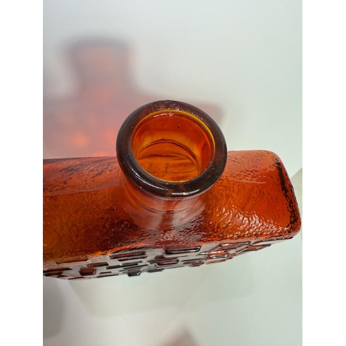 610 - An Empoli, Italy amber glass square narrow decanter with geometric design, 28.5cm; a heavy square am... 