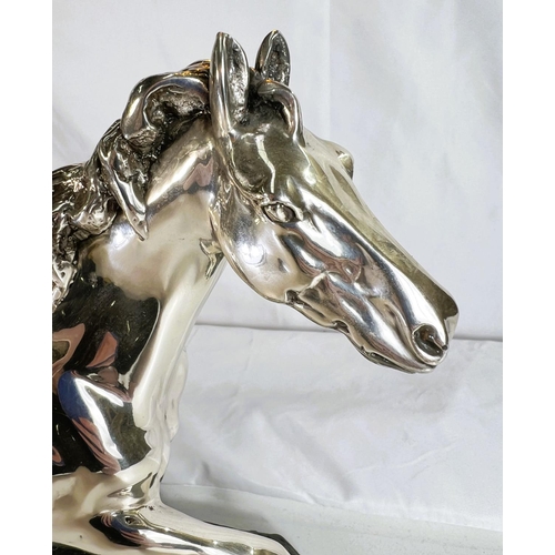 900 - A silvered metal sculpture of a horse on naturalistic bronzed base by 'D'Argenti', length 38cms.