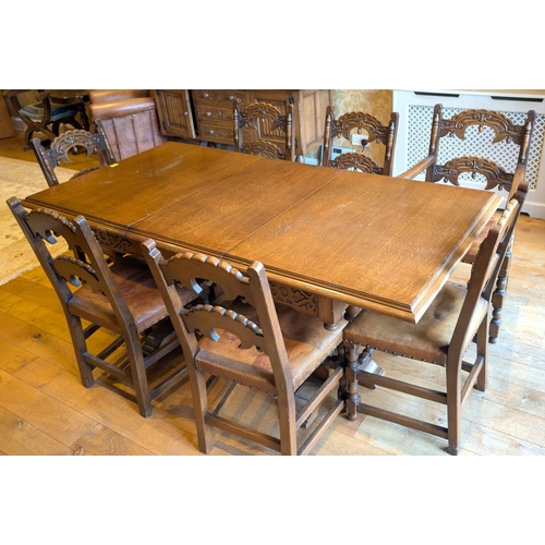 921 - A Jacobean style extending golden oak dining table and chairs and matching sideboard with carved bac... 