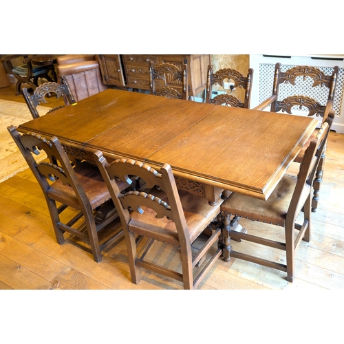 921 - A Jacobean style extending golden oak dining table and chairs and matching sideboard with carved bac... 