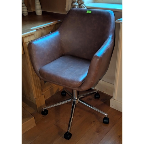 927 - A tan leather swivel office armchair.