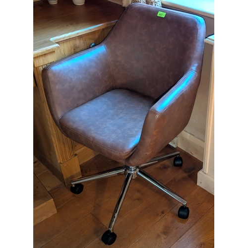 927 - A tan leather swivel office armchair.