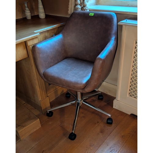 927 - A tan leather swivel office armchair.