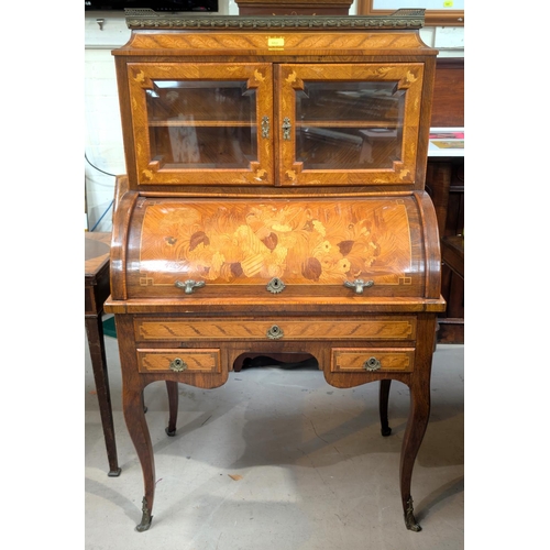 952 - A late 19th/early 20th century lady's cylinder bureau in the Louis XV manner with rosewood crossband... 