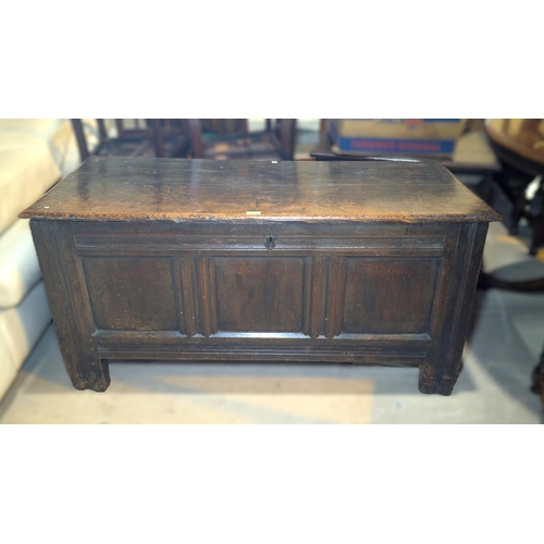 963 - An 18th century oak panel front chest with hinged lid