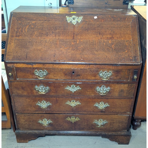 991 - A Georgian oak bureau, brass fittings with fitted interior, four long drawers on bracket feet, 91 x ... 