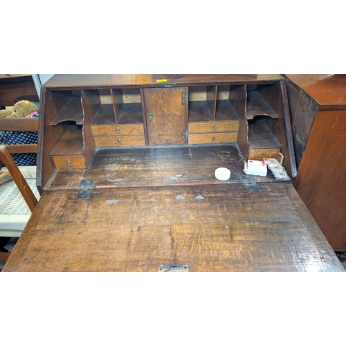 991 - A Georgian oak bureau, brass fittings with fitted interior, four long drawers on bracket feet, 91 x ... 