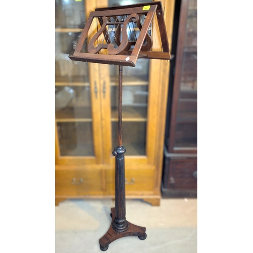 995 - A late 19th century rosewood duet music stand, rise and fall on tripod base.