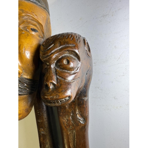 111 - An early 20th Century continental stick with carved head finial, 109cm, and another with ape finial,... 