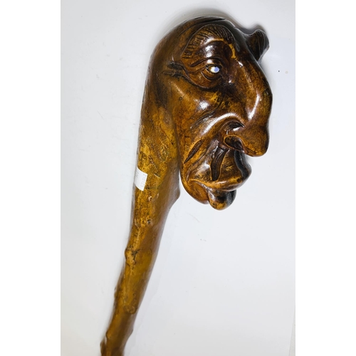 114 - A heavy natural wood finish staff with carved gargoyle finial, 112cm.