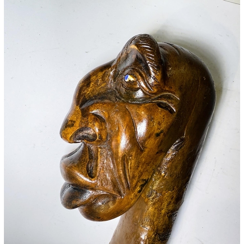 114 - A heavy natural wood finish staff with carved gargoyle finial, 112cm.