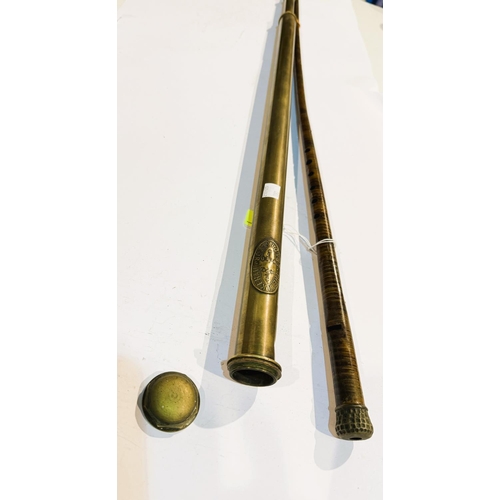 190 - An early 20th Century painted tin walking stick flute, 89cm, and a brass tubular weed eradicator (2)... 