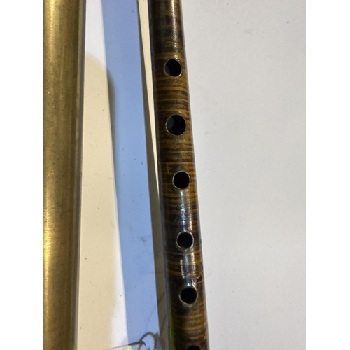 190 - An early 20th Century painted tin walking stick flute, 89cm, and a brass tubular weed eradicator (2)... 