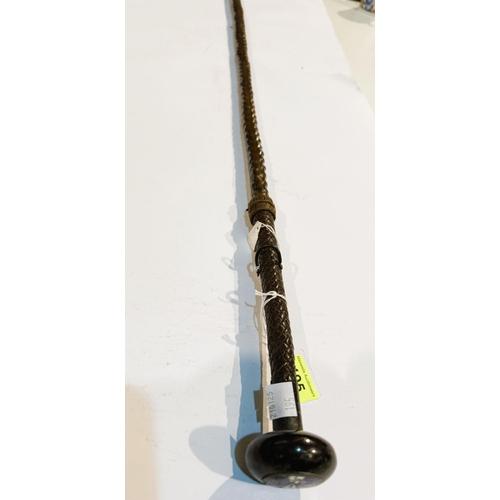 195 - A 19th Century Spanish stick with plaited leather handle concealing a spike, the button finial inset... 