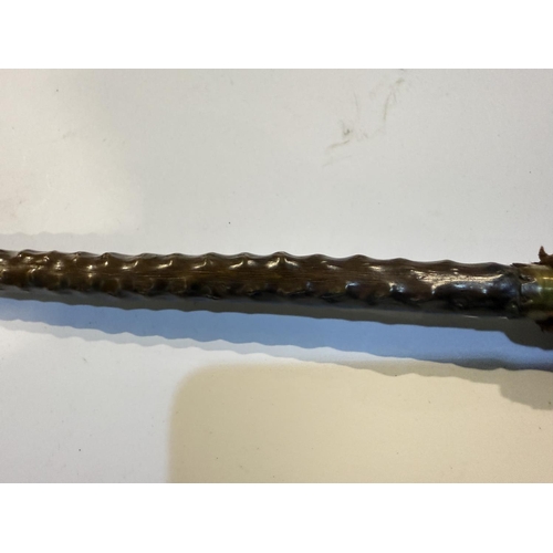 195 - A 19th Century Spanish stick with plaited leather handle concealing a spike, the button finial inset... 