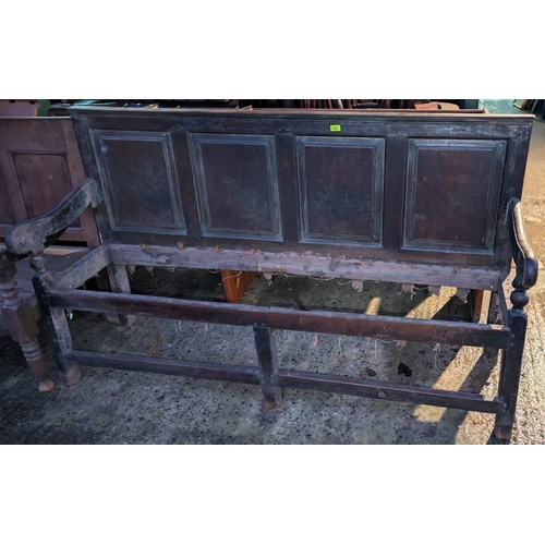 1044 - An 18th century oak settle with raised and fielded panels to the back, on square legs, length 184cm ... 