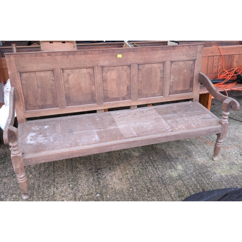 1055 - An 18th century oak settle with 5 panel back, sloped arms and turned legs, length 183cm; a 19th cent... 