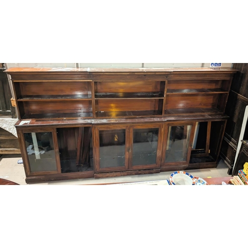 1098 - A late 19th/early 20th century very large mahogany breakfront library bookcase with open shelves abo... 