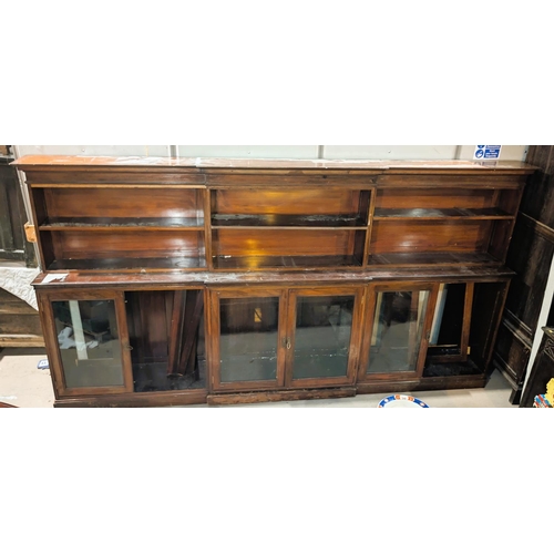 1098 - A late 19th/early 20th century very large mahogany breakfront library bookcase with open shelves abo... 