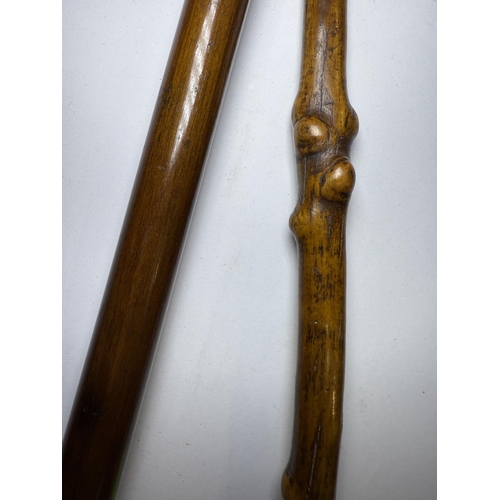 166 - A vintage wooden stick with dog's head handle and another with chequer work decoration, 86 and 94cm ... 