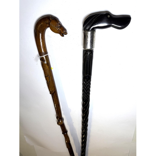 174 - An early 20th Century carved ebony walking stick with animal head finial and engraved silver collar,... 