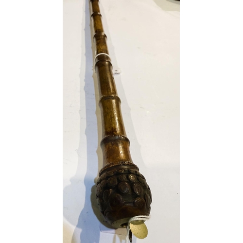 196 - A 19th Century bamboo cane with concealed gravity blade in the handle, 86cm.