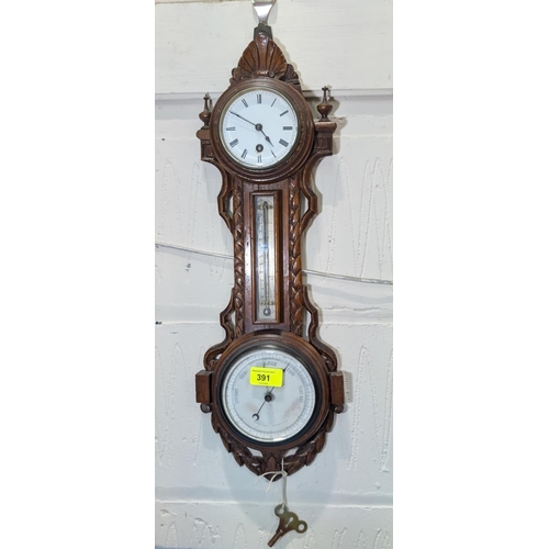 391 - A Victorian clock barometer in carved oak case (key attached)