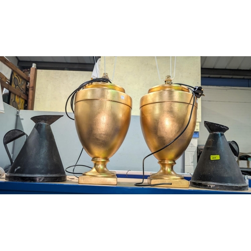 404 - A large pair of gilt table lamps, height 47cm; a large pair of 19th century conical measuring jugs.