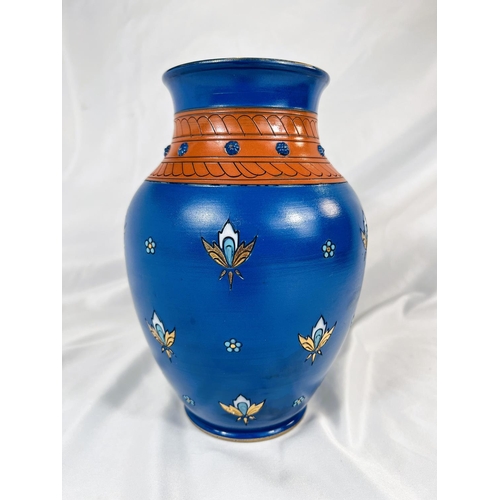 711 - A Mettlach blue ground baluster vase with stylised floral motifs, impressed mark, ht. 23cm