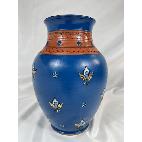 711 - A Mettlach blue ground baluster vase with stylised floral motifs, impressed mark, ht. 23cm